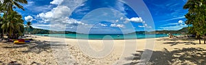 Blue Skies white Sandy Beach and turquoise waters of Patong Beach Phuket Thailand