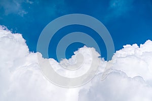 Blue sky above dense cloud, view from plane, with copy space at the middle