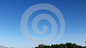 Blue sky above the trees at noon in Indonesia