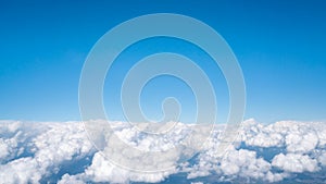 Blue sky above white fluffy cloud, cloudscape background with copy space