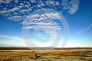 Blue sky and altocumulus clouds over Morecambe Bay