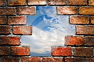 Blue sky through ancient brick wall