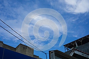 Blue sky background with a bit of cloud intensity with a building foreground