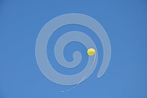 Blue sky background with bright balloon and no clouds