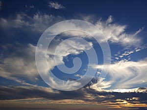 Blue sky background with colorful dramatic colorful clouds and sunlight