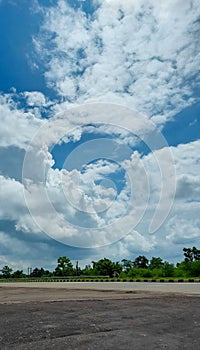 Blue sky background with cumulus white clouds, nature photography, sun rays, natural background, cloud wallpaper