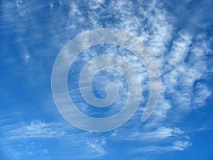 Blue sky background with fleecy clouds