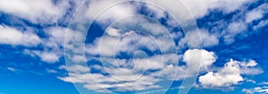 Blue sky background with fluffy white clouds