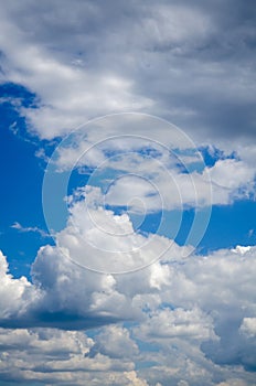 Blue sky background with gray fluffy clouds