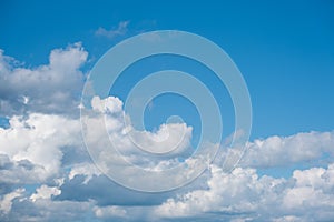 Blue sky background with puffy clouds