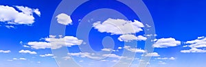 Blue sky background with tiny white clouds, panorama.