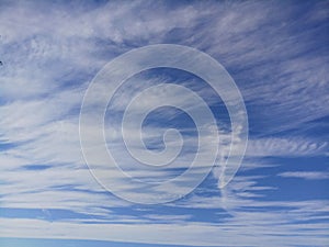 Blue sky background with white clouds.