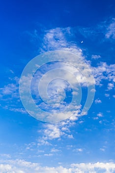 Blue sky background with white clouds and airplane