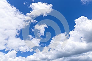 Blue sky background with white clouds, rain clouds.