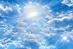 Blue sky background with white clouds and sun rays