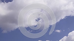 Blue sky background with white puffy cumulus clouds timelapse.