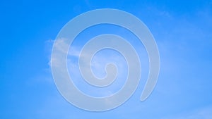 A blue sky with beautiful wisp of cloud for use as a backing or backdrop