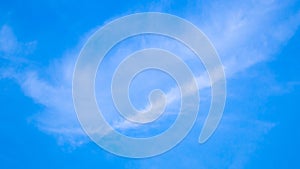 A blue sky with beautiful wisp of cloud for use as a backing or backdrop