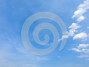 A blue sky with beautiful wisp of cloud for use as a backing or backdrop