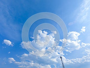A blue sky with beautiful wisp of cloud for use as a backing or backdrop