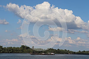 Big clouds over river towboat photo