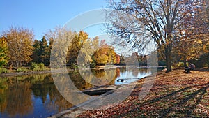 Blue sky blue river waters with autumn colors yellow green red