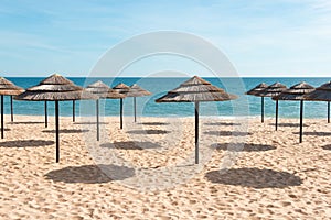 Blue sky, blue sea and parasols at beach in Portugal