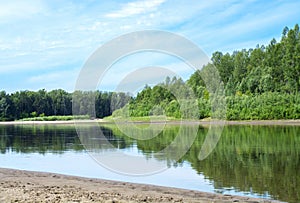 Blue sky on a calm summer day. Bend of the river in Siberia  forest near water