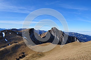 Blue sky in the swiss foothils and fog lake over the flatland