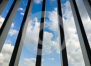 Blue sky with the cloud view through the metal grille