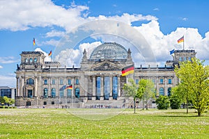 The German Federal Parliament (Reichstag) building in Berlin, with German flags