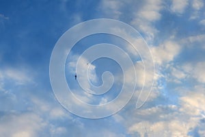 Blue sky with clouds and abstract image of face