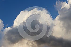 Big gray and white clouds on a blue sky background