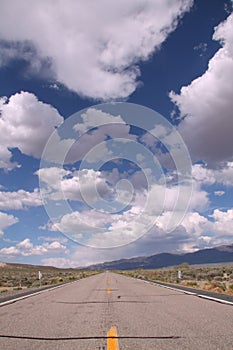 Blue sky with clouds in the desert and a road