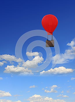 Blue sky with clouds, floating hot-air balloon