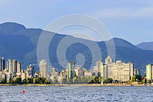 Blue sky with clouds, a modern seaside town with mountains