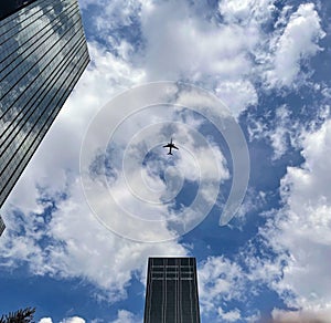 Blue sky, clouds, plane in flight