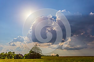 Blue sky with clouds and sun rays, dreamy landscape