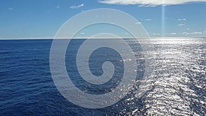 Blue sky with clouds in sunny weather over the ocean.