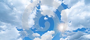 Blue sky, cloudscape background banner panorama , with clouds and sun reflection / sunshine sunbeams