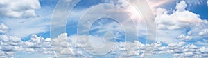 Blue sky, cloudscape background banner panorama , with clouds and sun reflection / sunshine sunbeams - summer weather