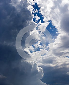 Blue sky coming out from behind dark blue stormy clouds