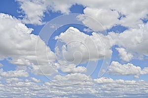 Blue sky covered with large white clouds.