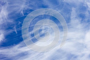 Blue sky and feathery clouds