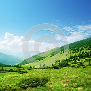 Blue sky and green hills