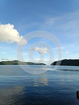 Blue sky and green island of sangihe photo