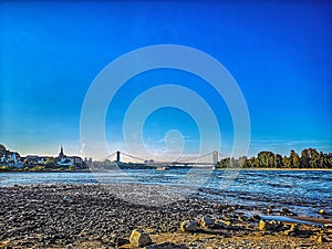 Blue Sky in the Green wirh View on the other Side of the River Rhein in Cologne Germany Nature sandbeach and trees