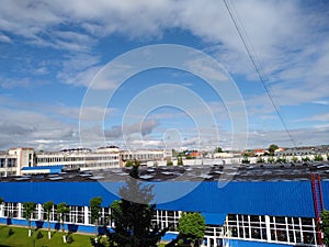Blue sky and blue industrial building in sunny day. Citi photo