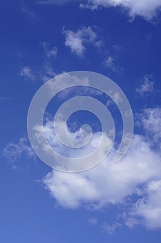 Blue sky with many small fluffy cumulus clouds .