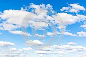 Blue sky with many white cumuli clouds